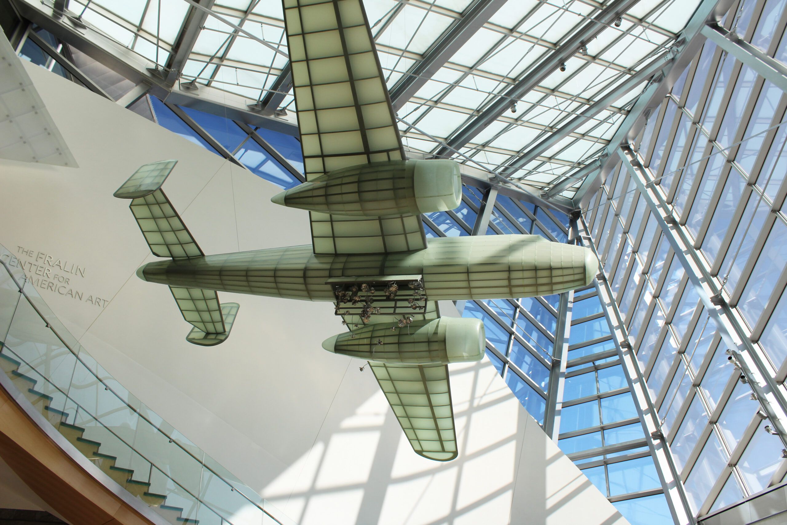 Plane hanging from ceiling with stainless steel flowers falling out