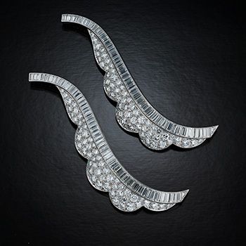 Angelina Jolie - Pair of matching round and baguette diamond, platinum, stylized swirl brooches, circa 1950 (mid- century), Courtesy Neil Lane Couture