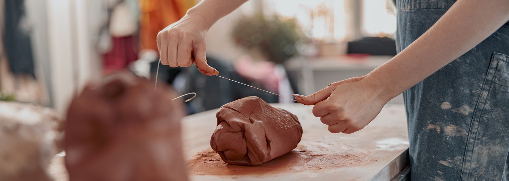 Diligent master molding clay product in ceramics workshop