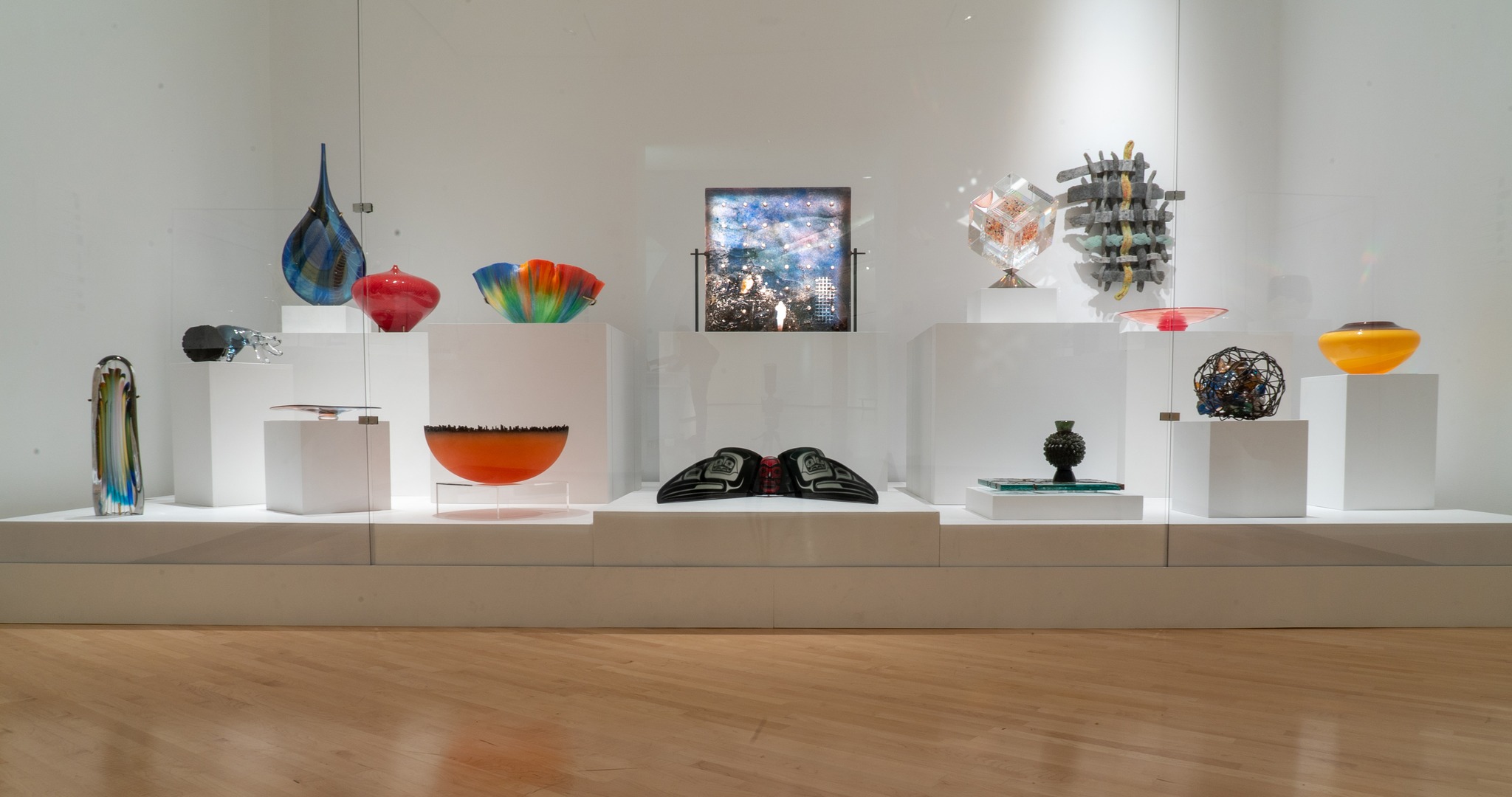 Gallery featuring several glass works in bright, bold colors