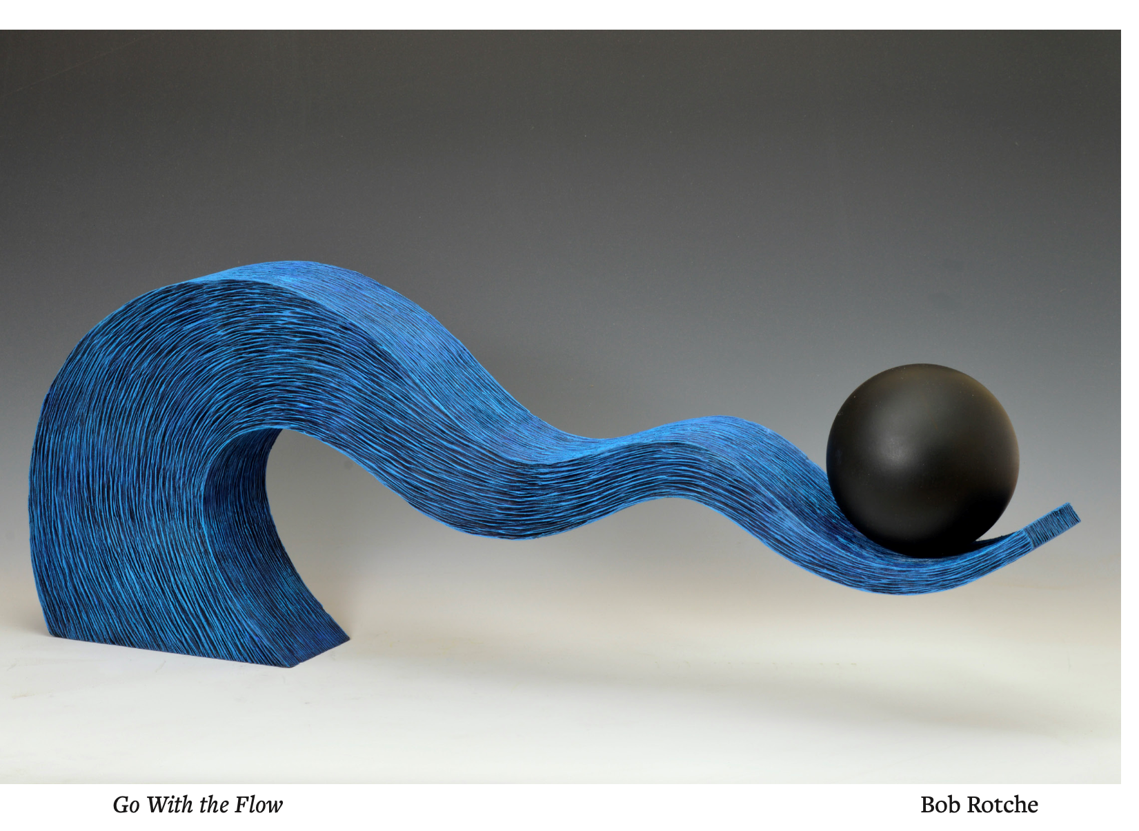 This digital rendering features a three dimensional, branch-like structure in the color blue that balances a black sphere at the very tip