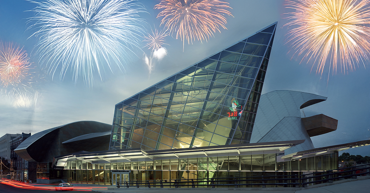 The exterior of the Taubman Museum of Art at dusk with fireworks overhead