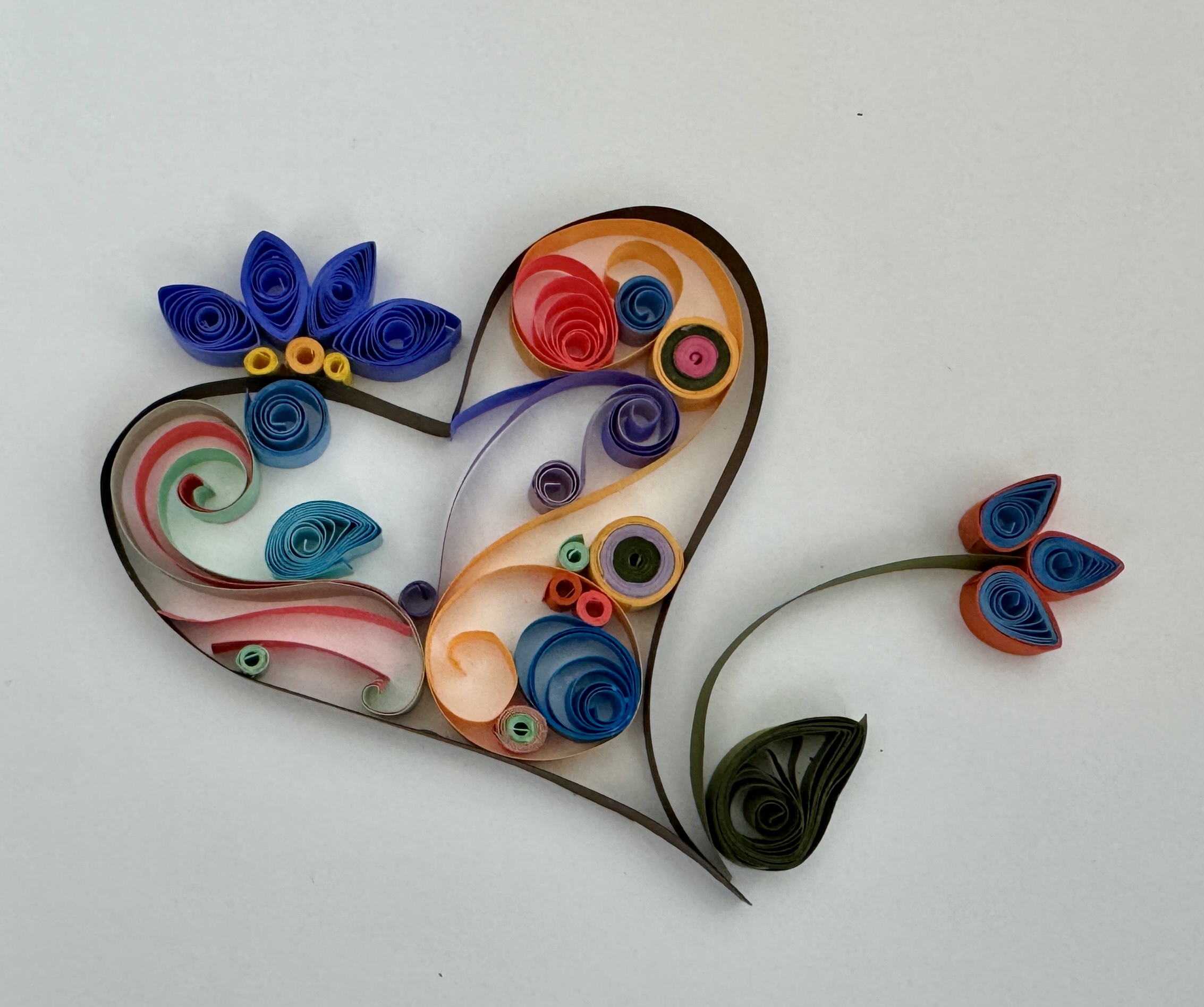 A heart shape made from paper tightly coiled into various designs