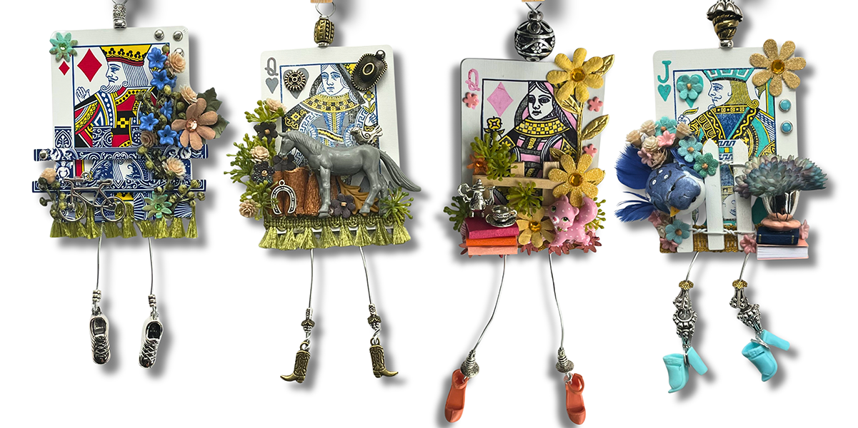 Four playing cards from a deck decorated with whimsical features like wire legs and shoes, beads, and ribbons
