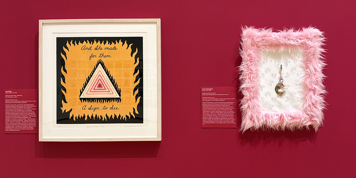 Two contemporary artworks displayed on a vibrant burgundy wall; one work features a white, red, and black triangle with the works 